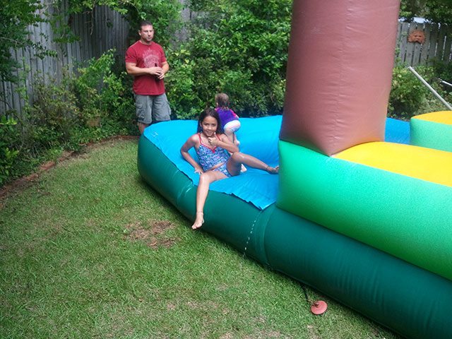 Slip n Slide Pool Waterslide AT a Birthday Party - Little Girl Given A Thumbs Up After Ridinging 